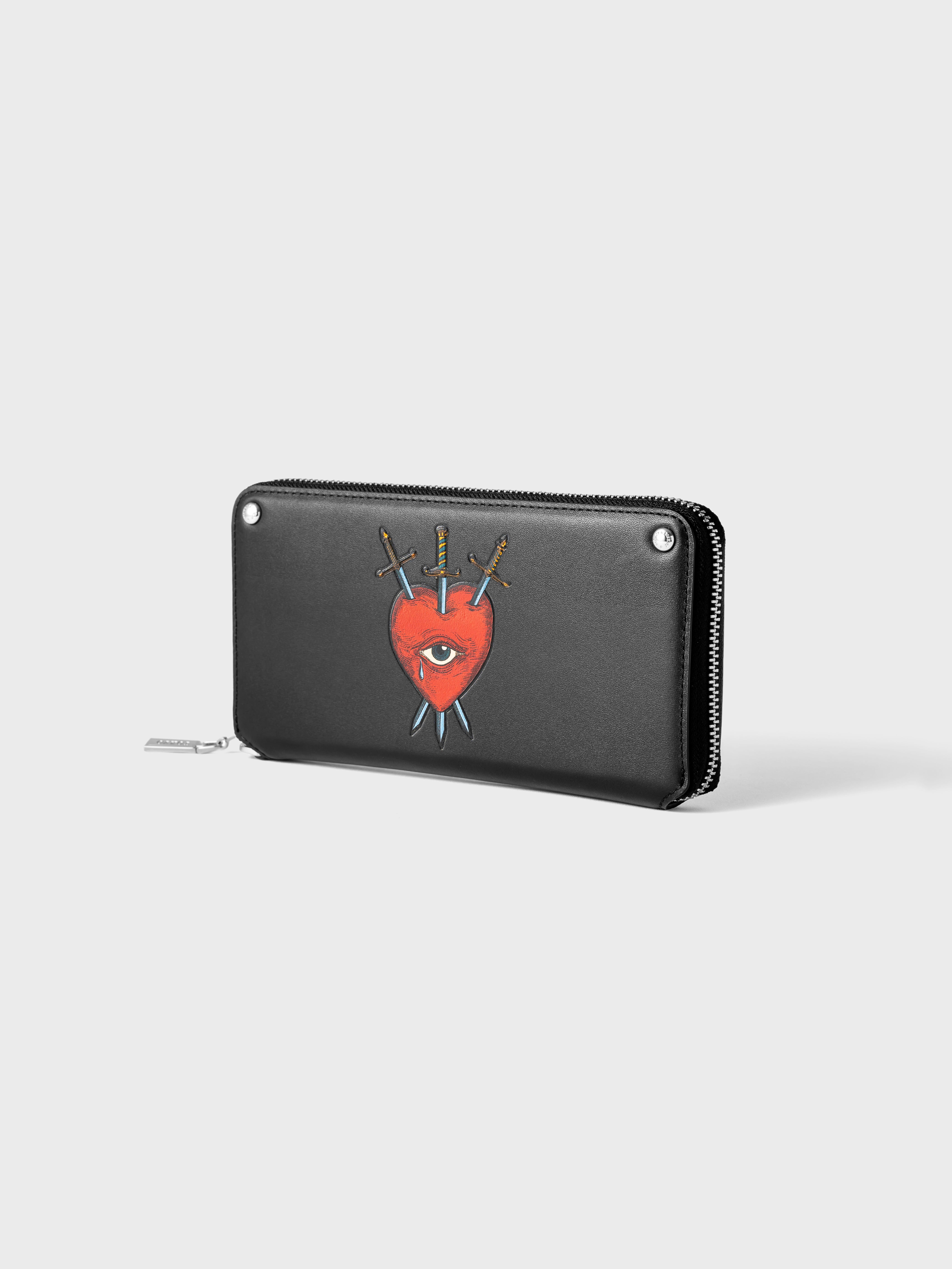 Black wallet with a silver zipper, featuring a red heart with an eye pierced by three swords graphic.