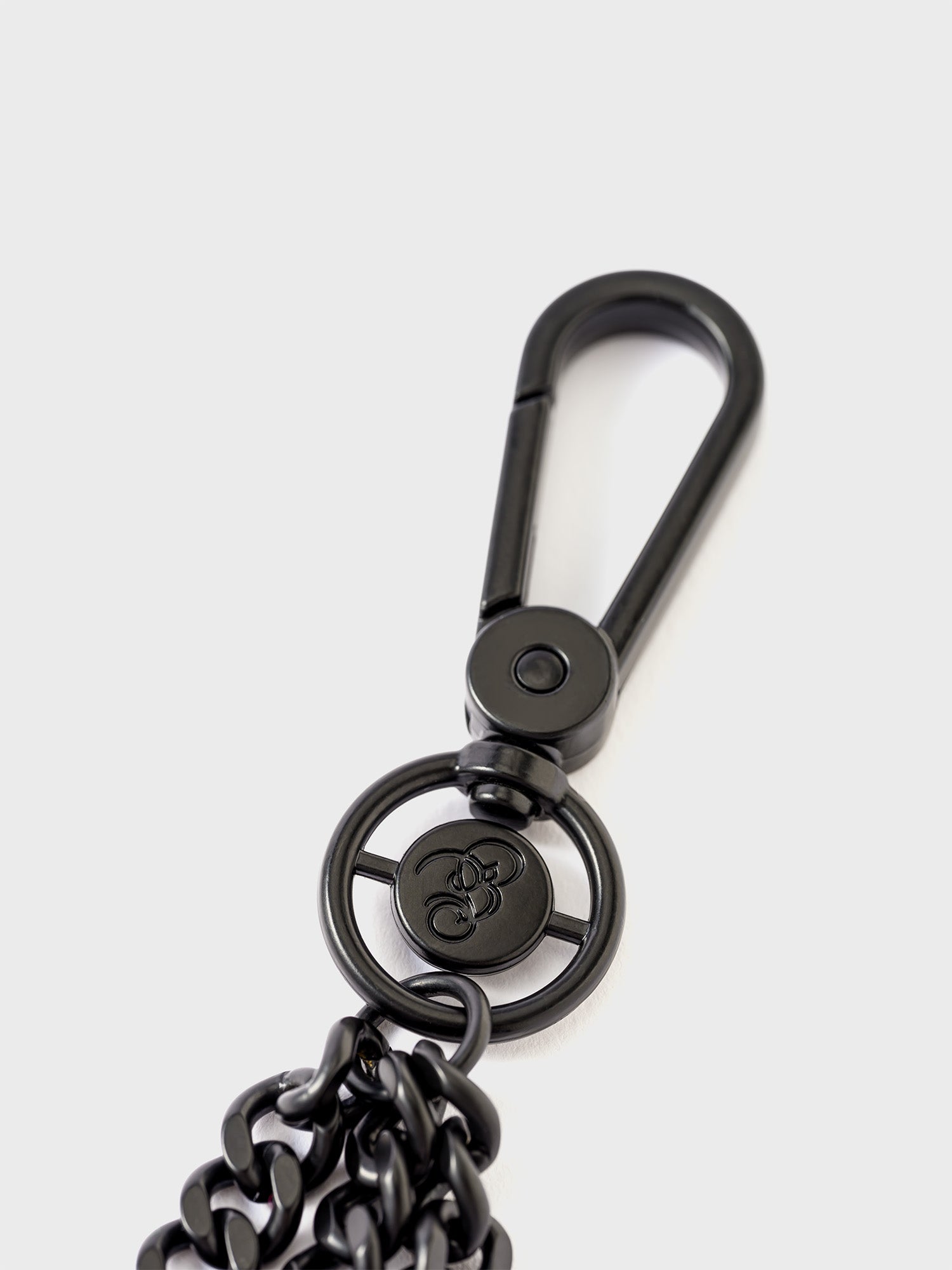 Close-up of a black clasp featuring the Bishop & Bishop monogram.
