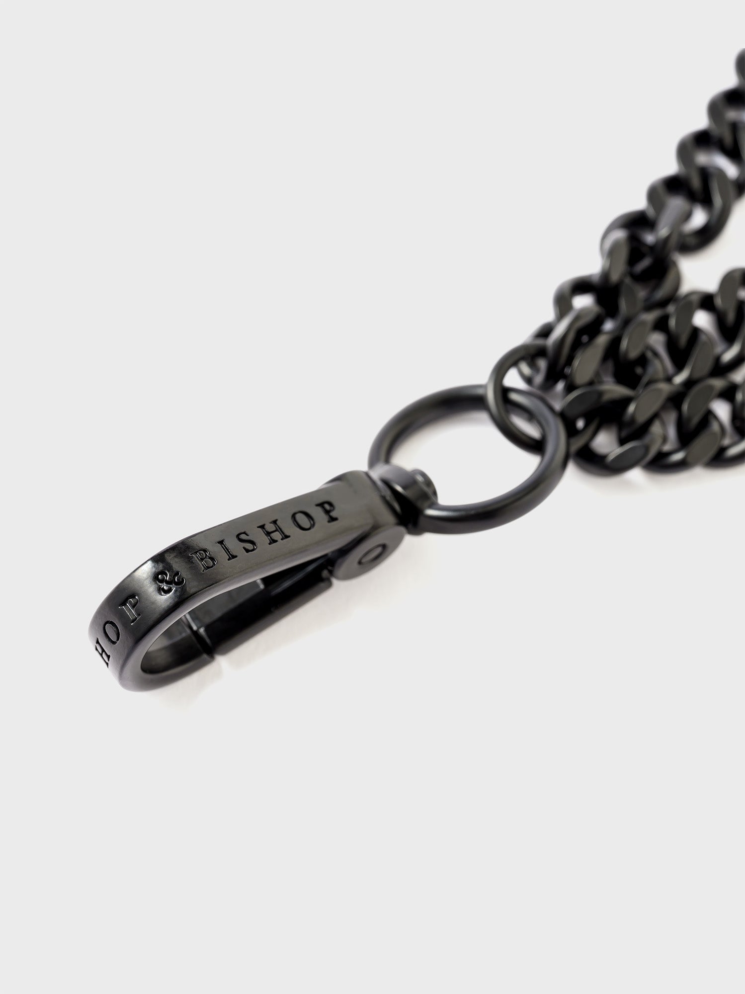 Close-up of a black clasp engraved with the “Bishop & Bishop” logo.
