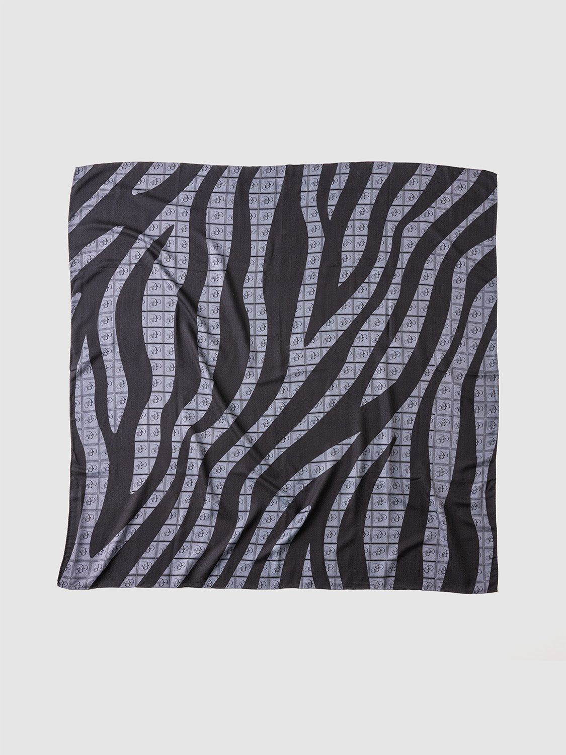 A black and charcoal zebra print stole with the Bishop & Bishop monogram woven into the fabric.