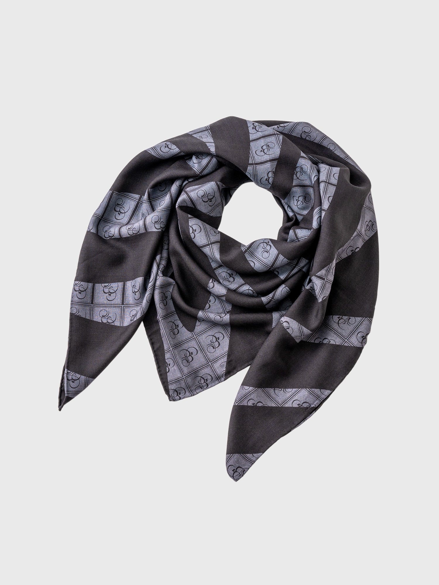 A black and charcoal zebra print stole with the Bishop & Bishop monogram woven into the fabric.
