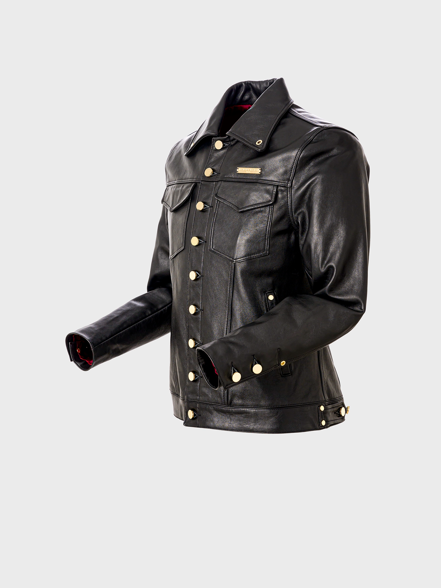 Side view of a black trucker jacket with gold parts, featuring a collar, front button-up design, and distinctive zinc alloy hardware.