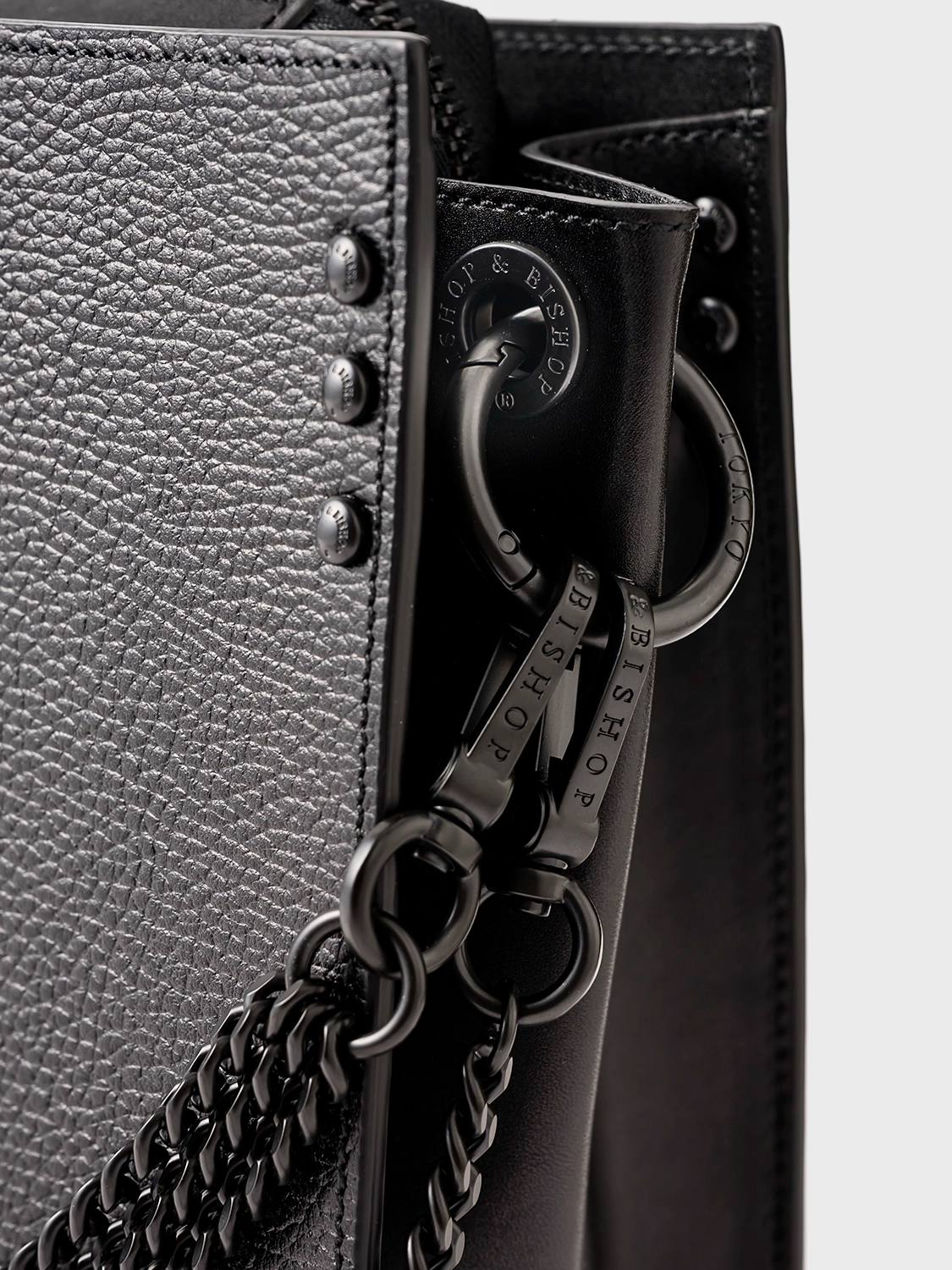 Black bag with a black clasp and black chain strap.