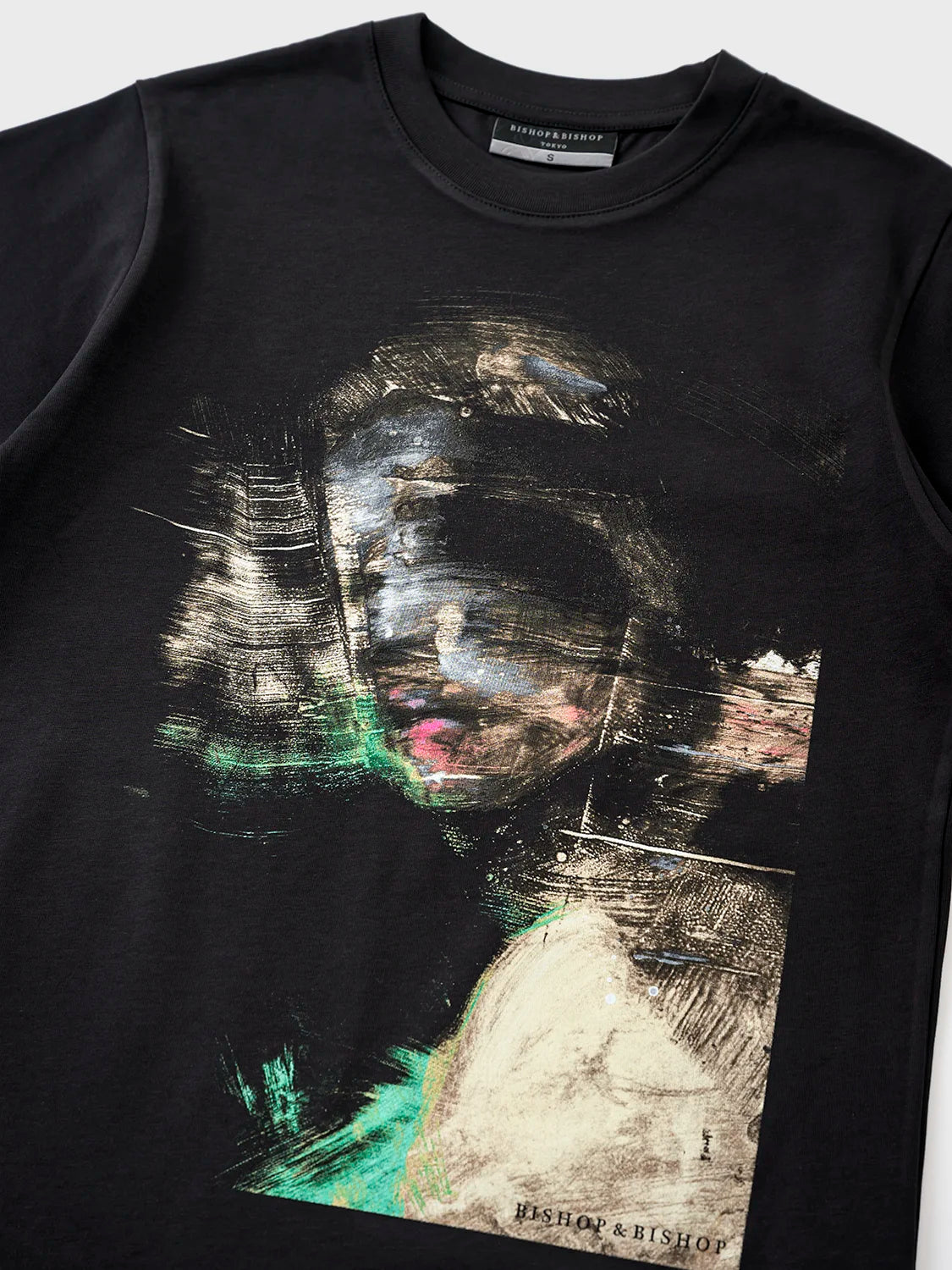 A black Peccatum T-shirt with a bold silicone and Japanese screen print featuring the hand-painted artwork 'Fables of the Grease Coated Heart' by artist Eric Cox.