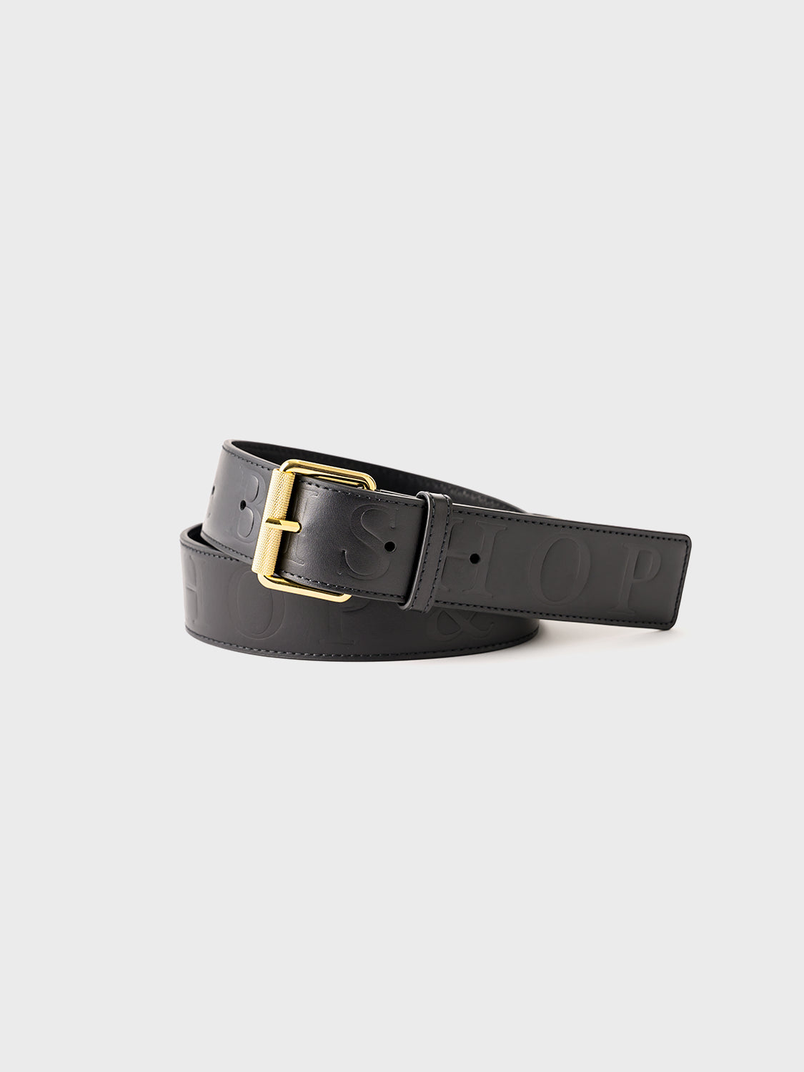 A black embossed leather belt with gold hardware, displayed against a white background.
