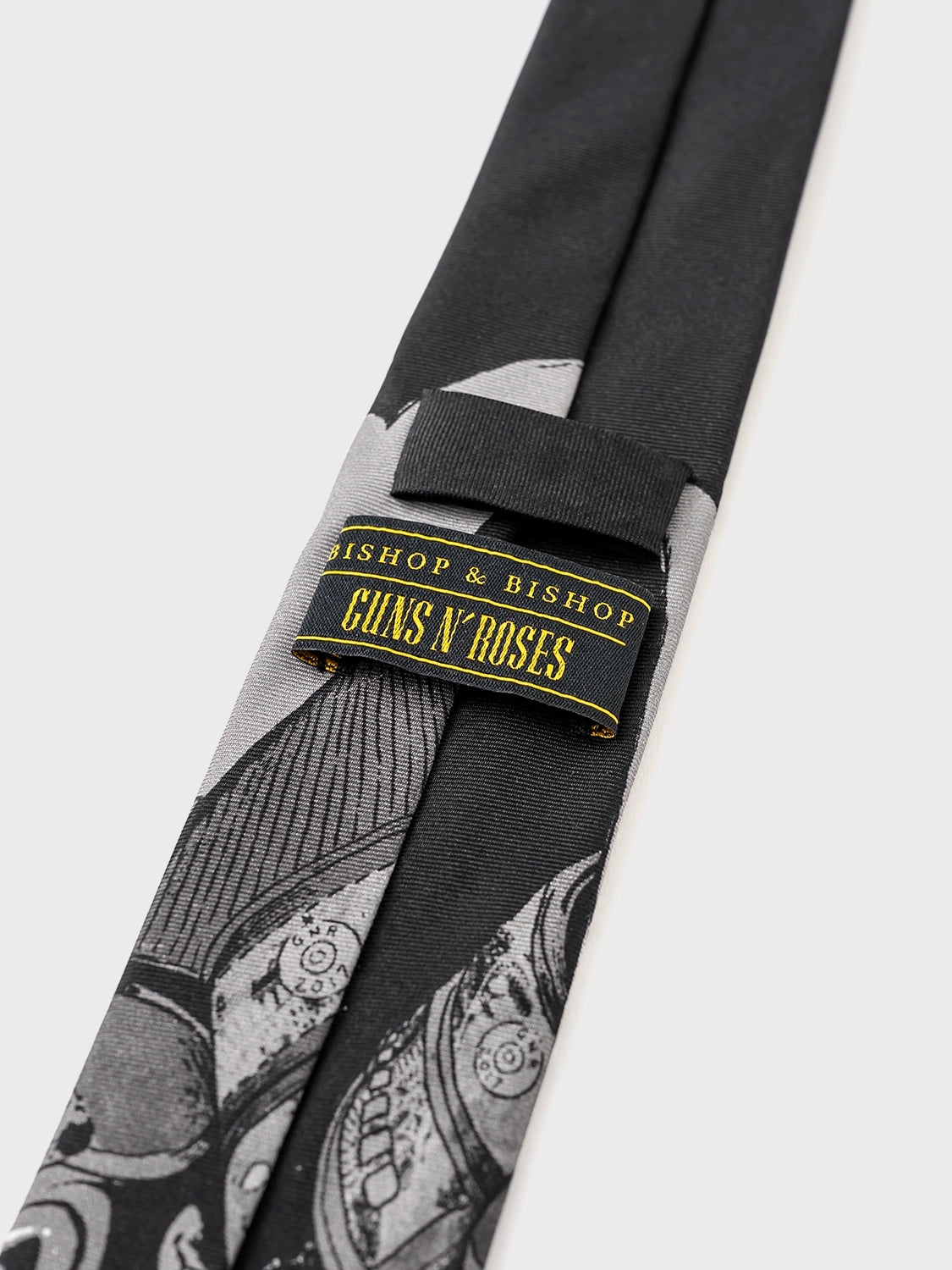Tie with a label reading 'Guns N' Roses' on a white background