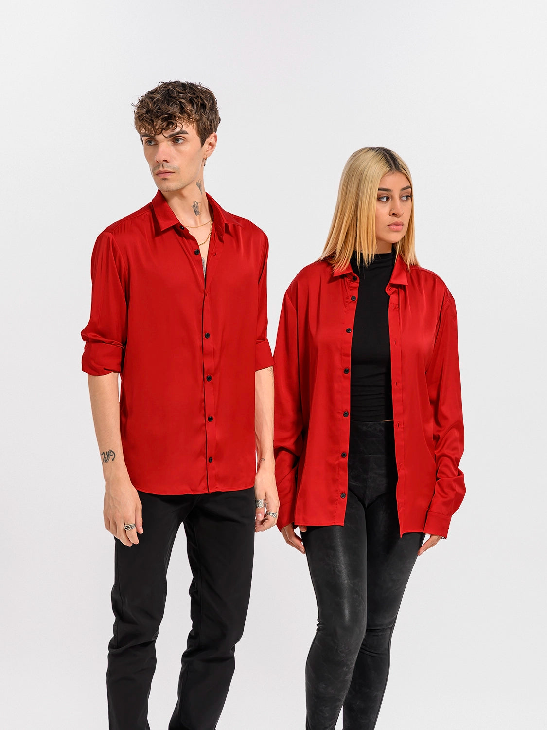 Two people wearing red button-up shirts on a white background