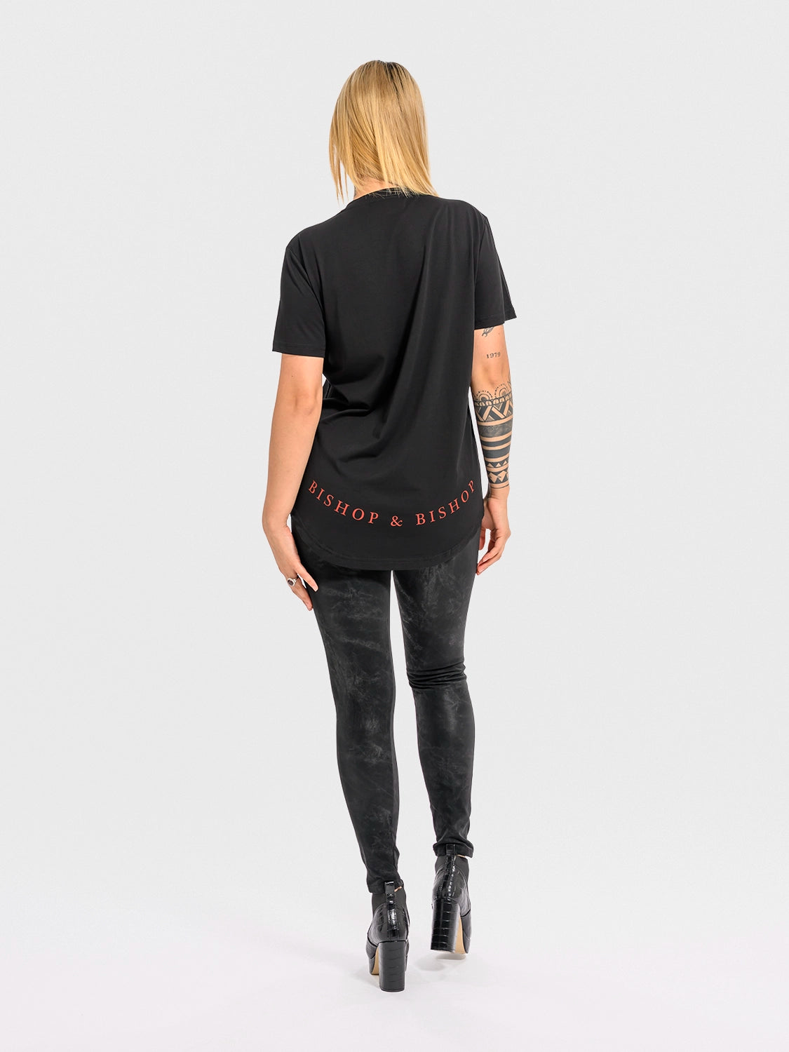 Person wearing a black t-shirt with 'Bishop & Bishop' branding on a white background