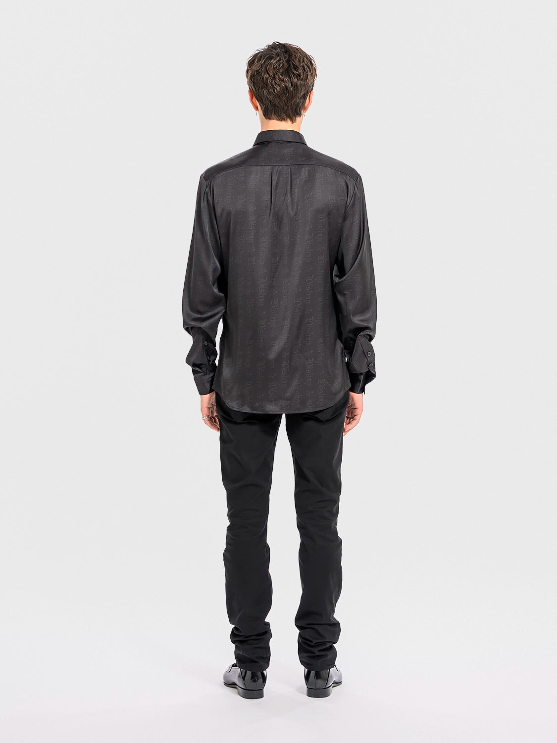 Man wearing a black shirt and pants on a white background