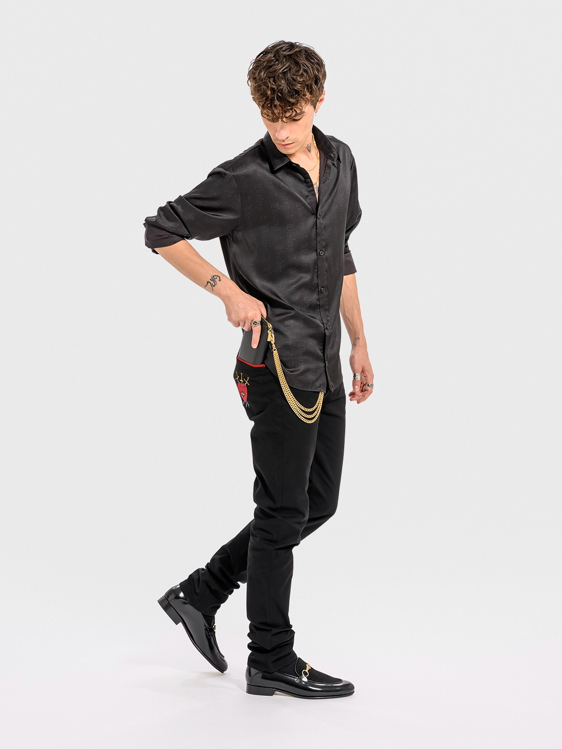 Person wearing a black outfit with a white background