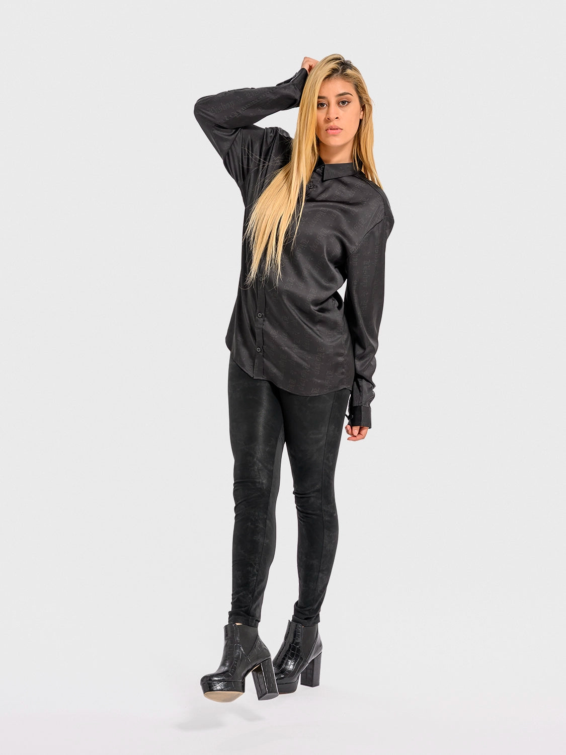 Woman wearing a black outfit on a white background