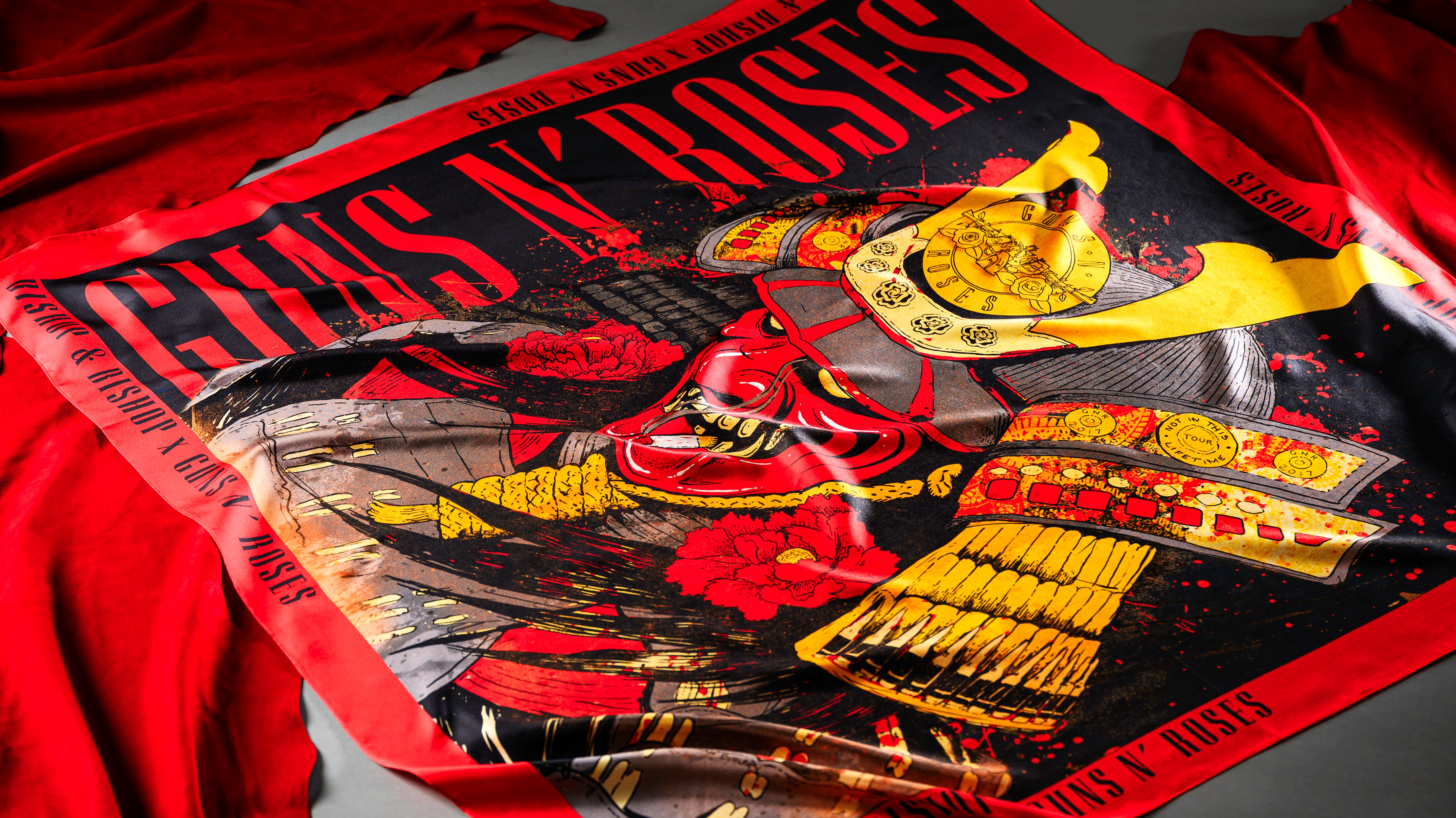 Red and yellow scarf with “Bishop & Bishop x Guns N’ Roses” text, featuring a graphic of a red demon samurai.