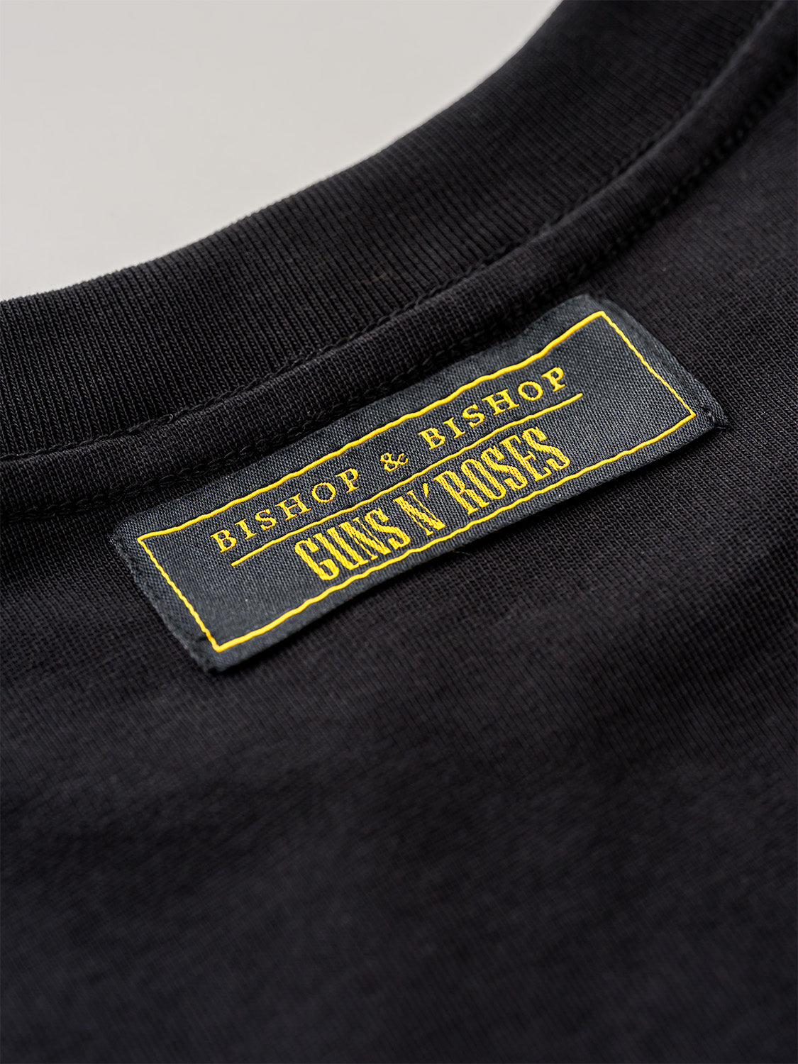 Black t-shirt with 'Bishop & Bishop Guns N' Roses' label on a gray background