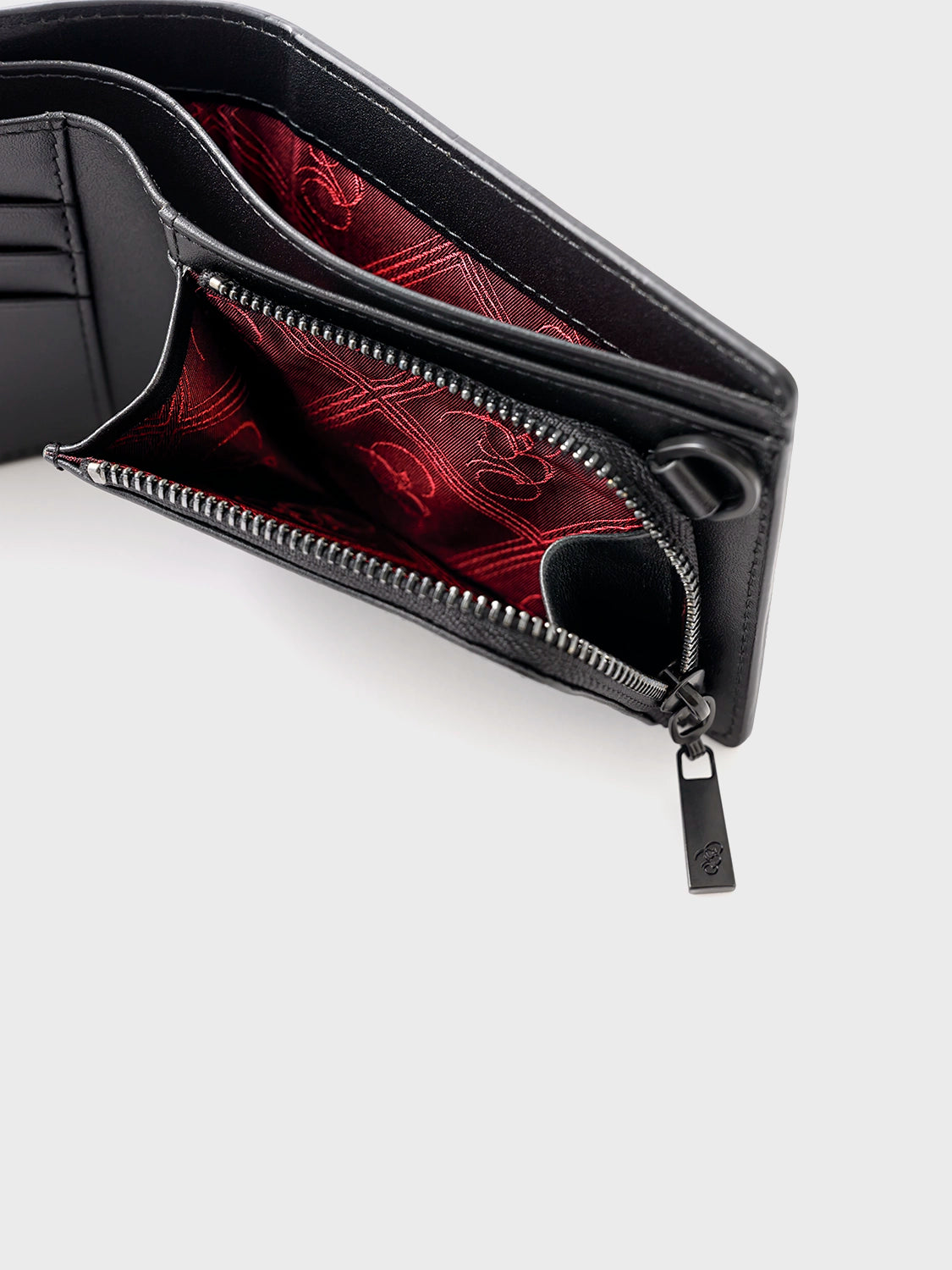 Close-up of the wallet interior featuring the zippered coin pouch, billfold section, and deep red accent lining.
