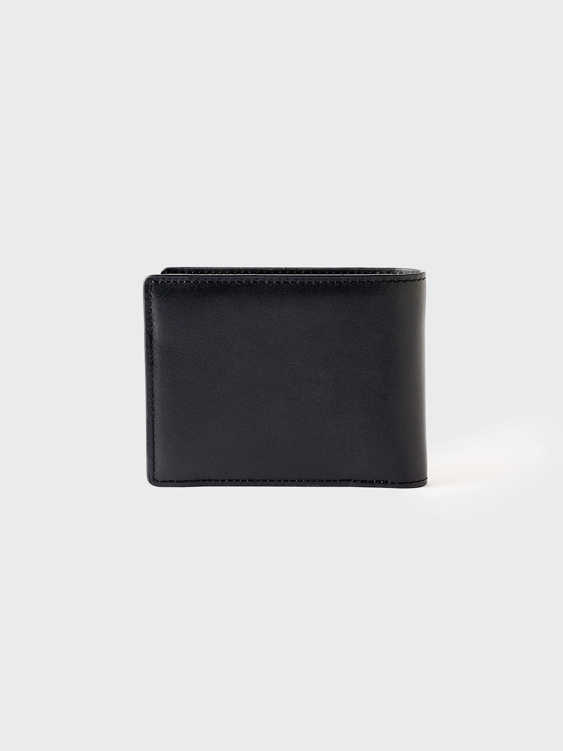 Rear view of the black leather Billfold Wallet, showcasing uninterrupted leather back surface and subtle structural lines.