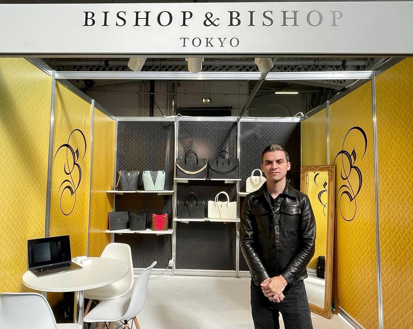 Erik standing in front of a “Bishop & Bishop Tokyo” sign