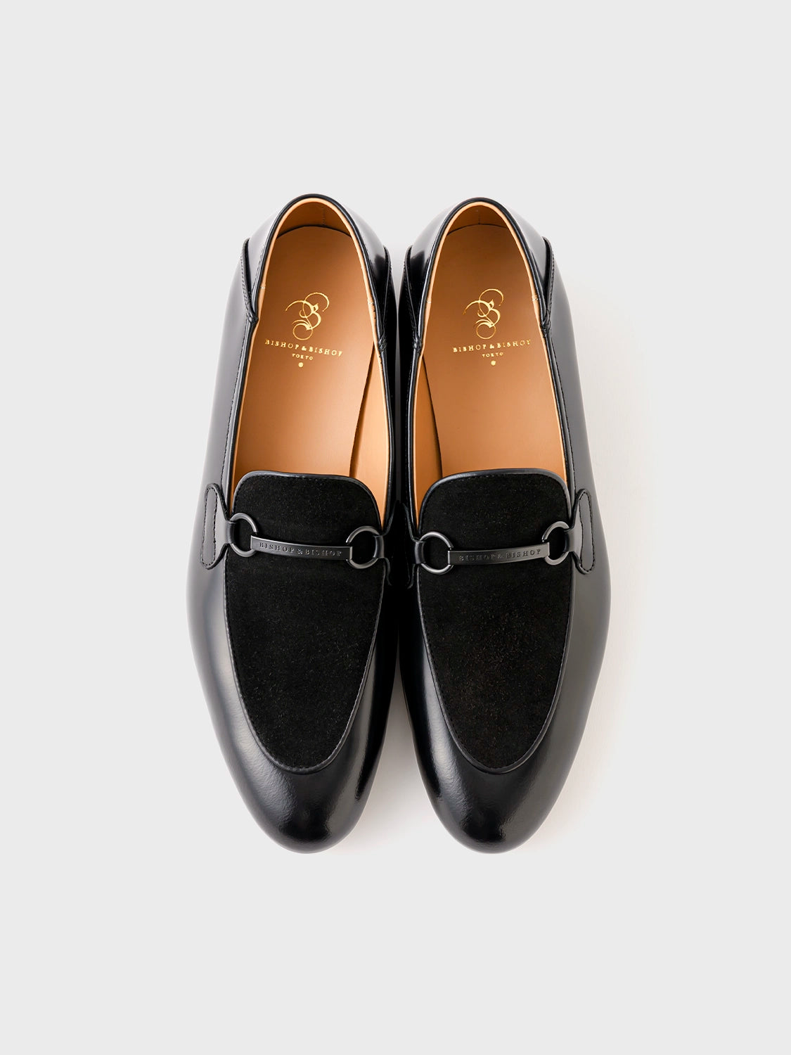 op-down view of the black leather loafer pair, highlighting symmetry and refined craftsmanship.