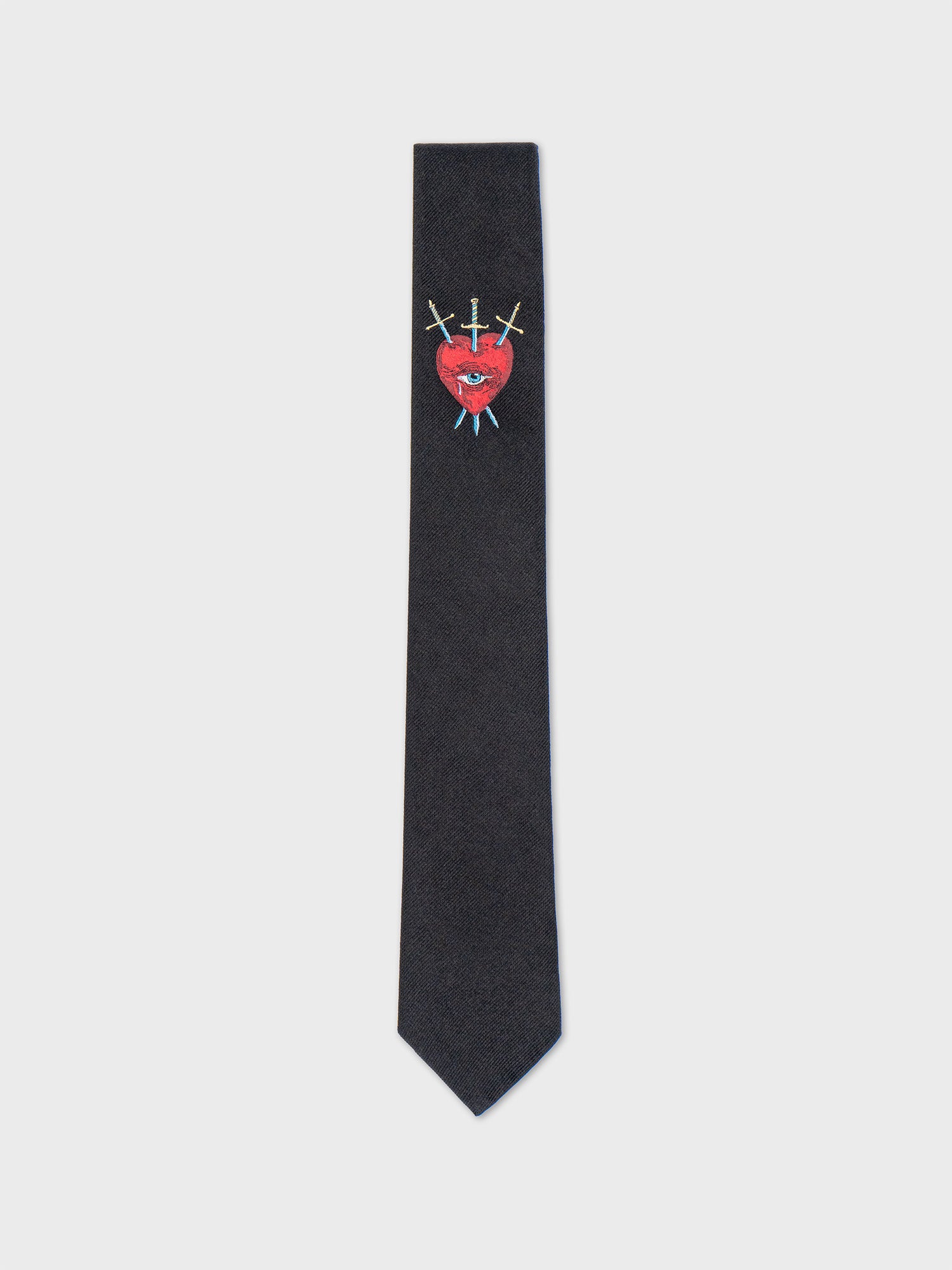 A black tie with a red heart, an eye, and crossed swords design