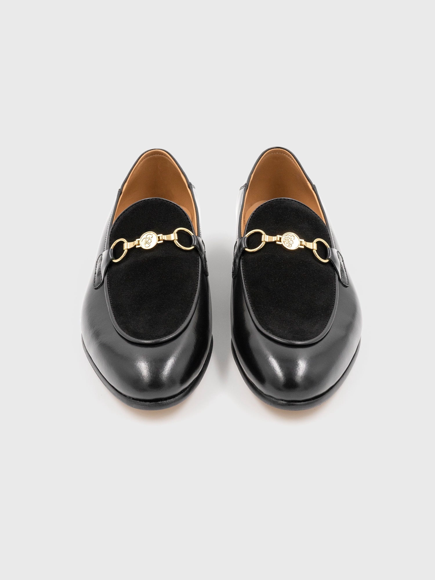 Pair of black shoes with gold detailing