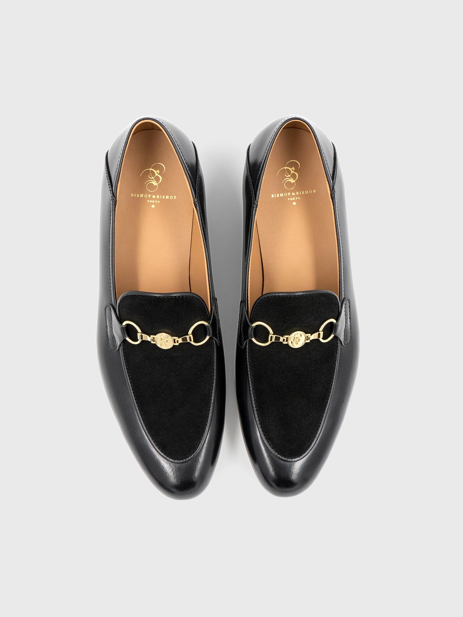 Pair of black shoes with gold detailing, showing “Bishop & Bishop Tokyo” printed inside.