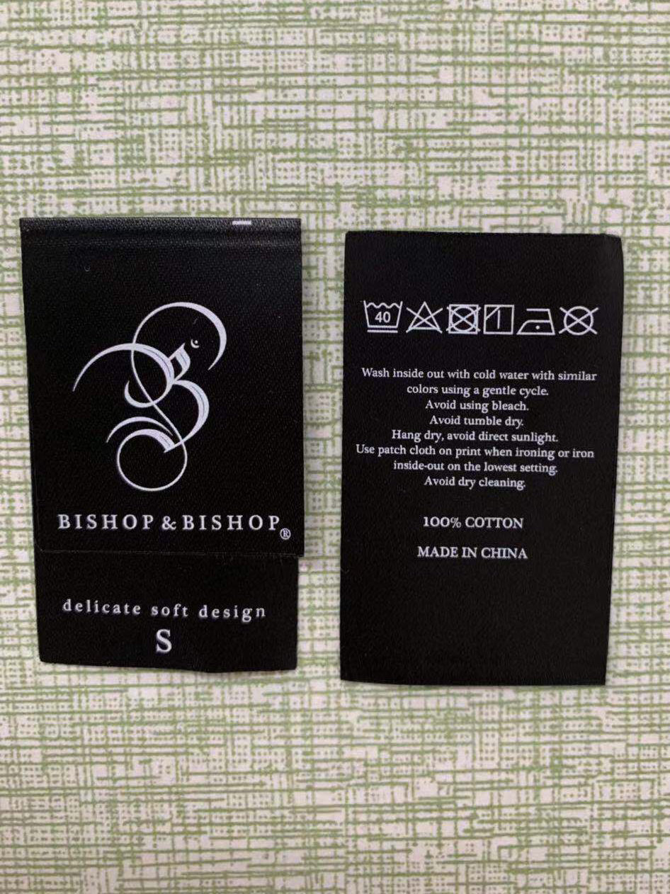 Close-up of the first label samples created for Bishop & Bishop’s original tour T-shirts.