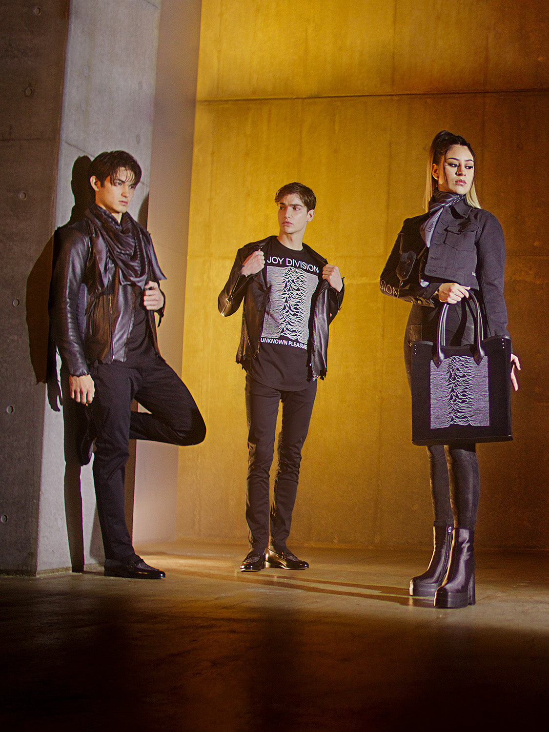 Group of people wearing Bishop & Bishop clothing with Joy Division graphics, posing together.