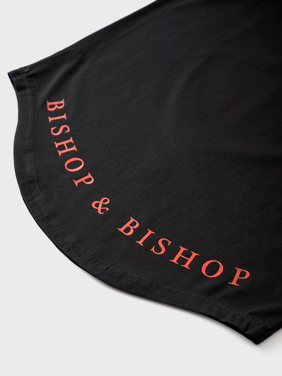Close up of the back of black T-shirt with "Bishop & Bishop" words