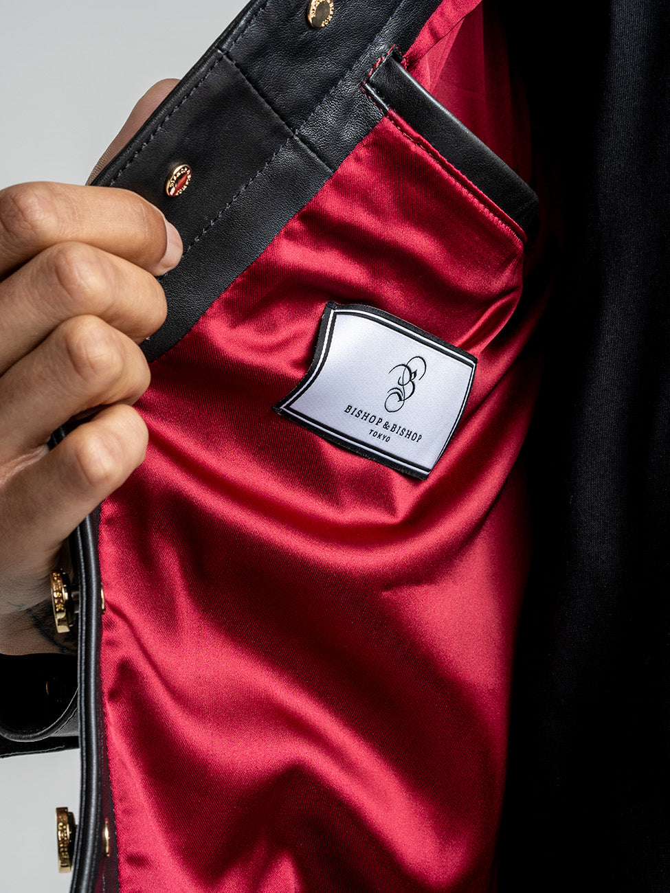 Close-up of the jacket’s interior, showing the red lining and Bishop & Bishop label.