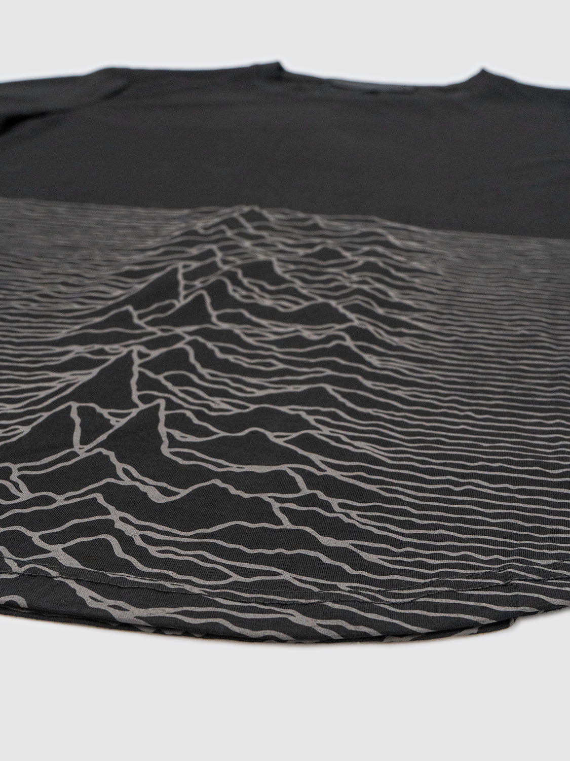Close-up of the all-over print section highlighting the fluid waveform design and fabric texture.