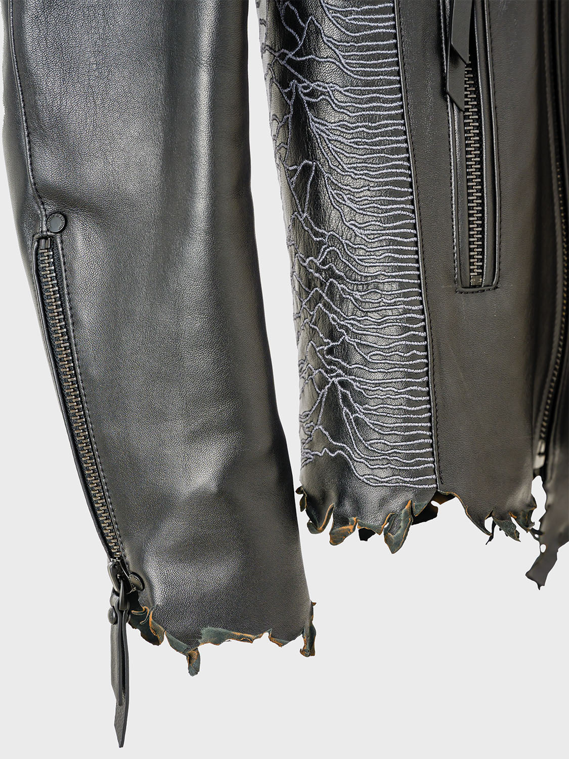 Side close-up of the tonal Unknown Pleasures embroidery subtly stitched into the leather.