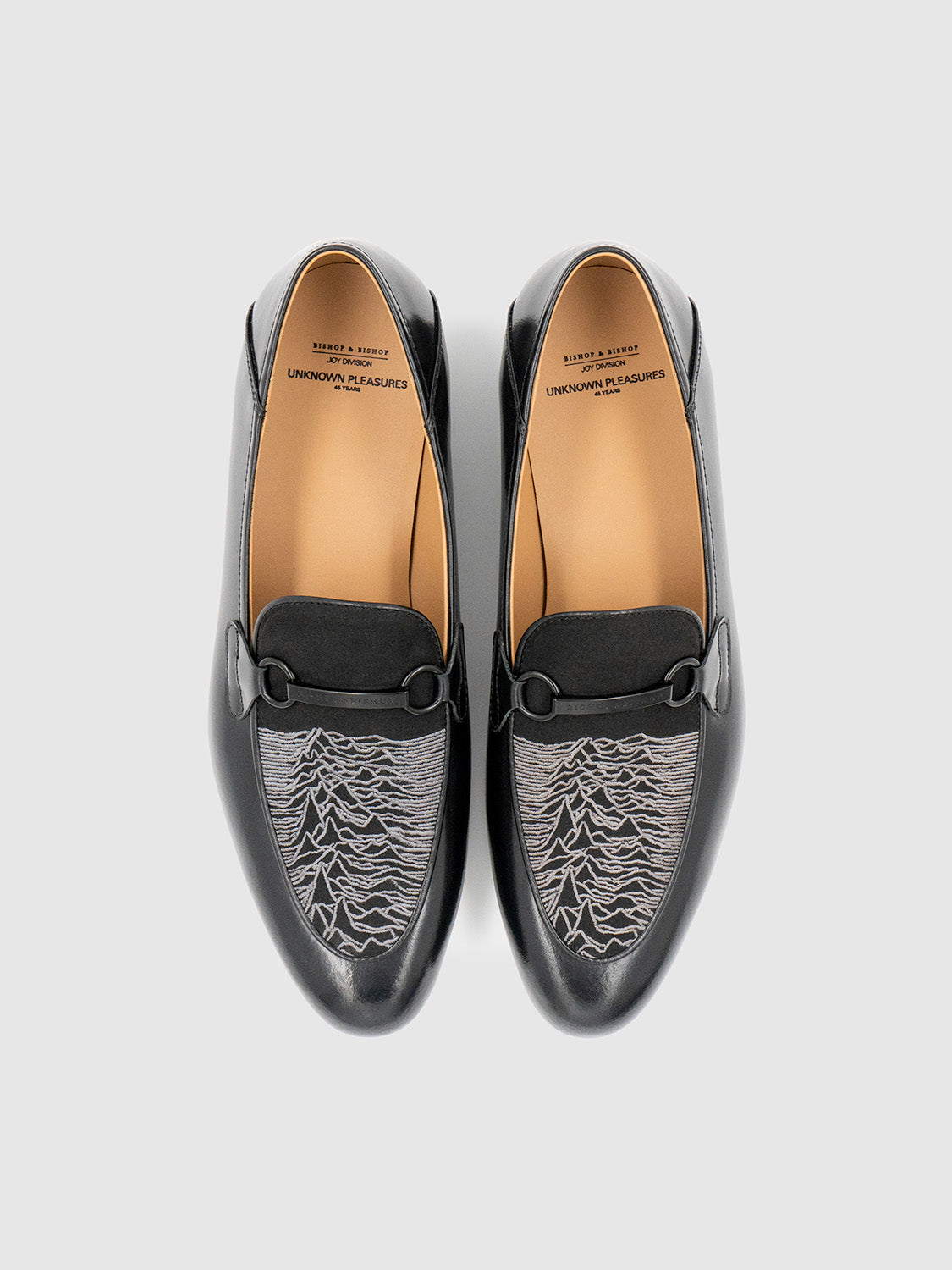 Top-down view of the loafer pair revealing the symmetry and waveform embroidery details.