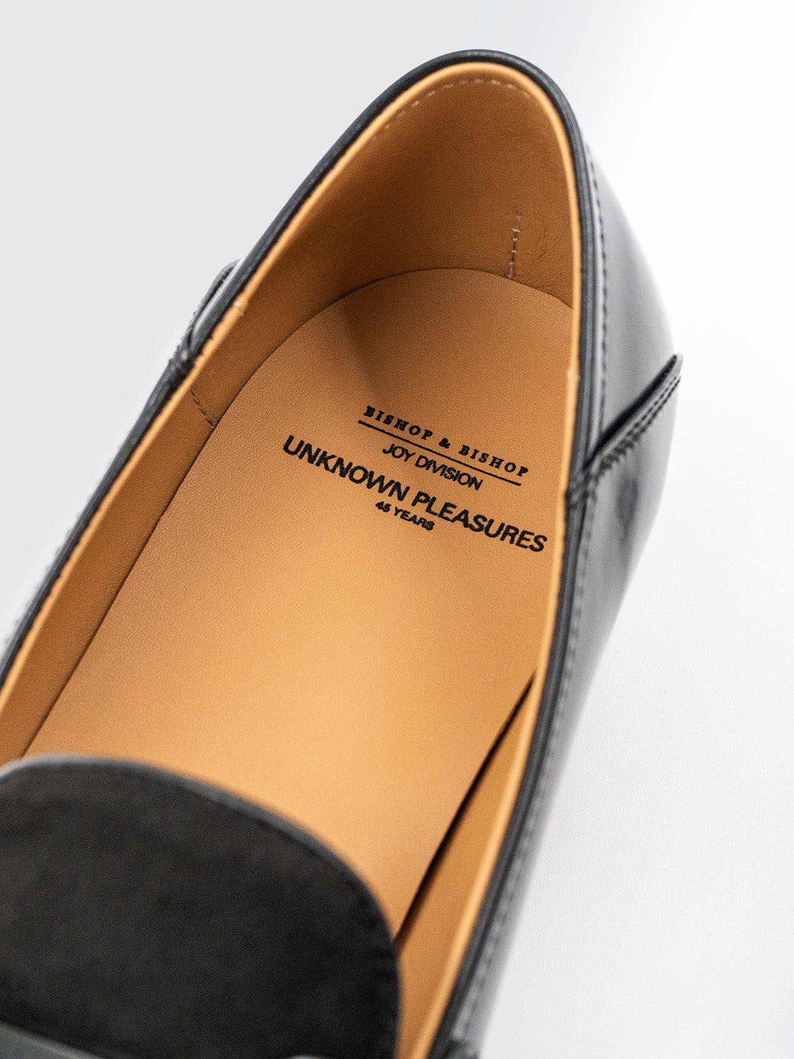 Angled interior shot of a loafer showing the insole branding and natural leather lining.
