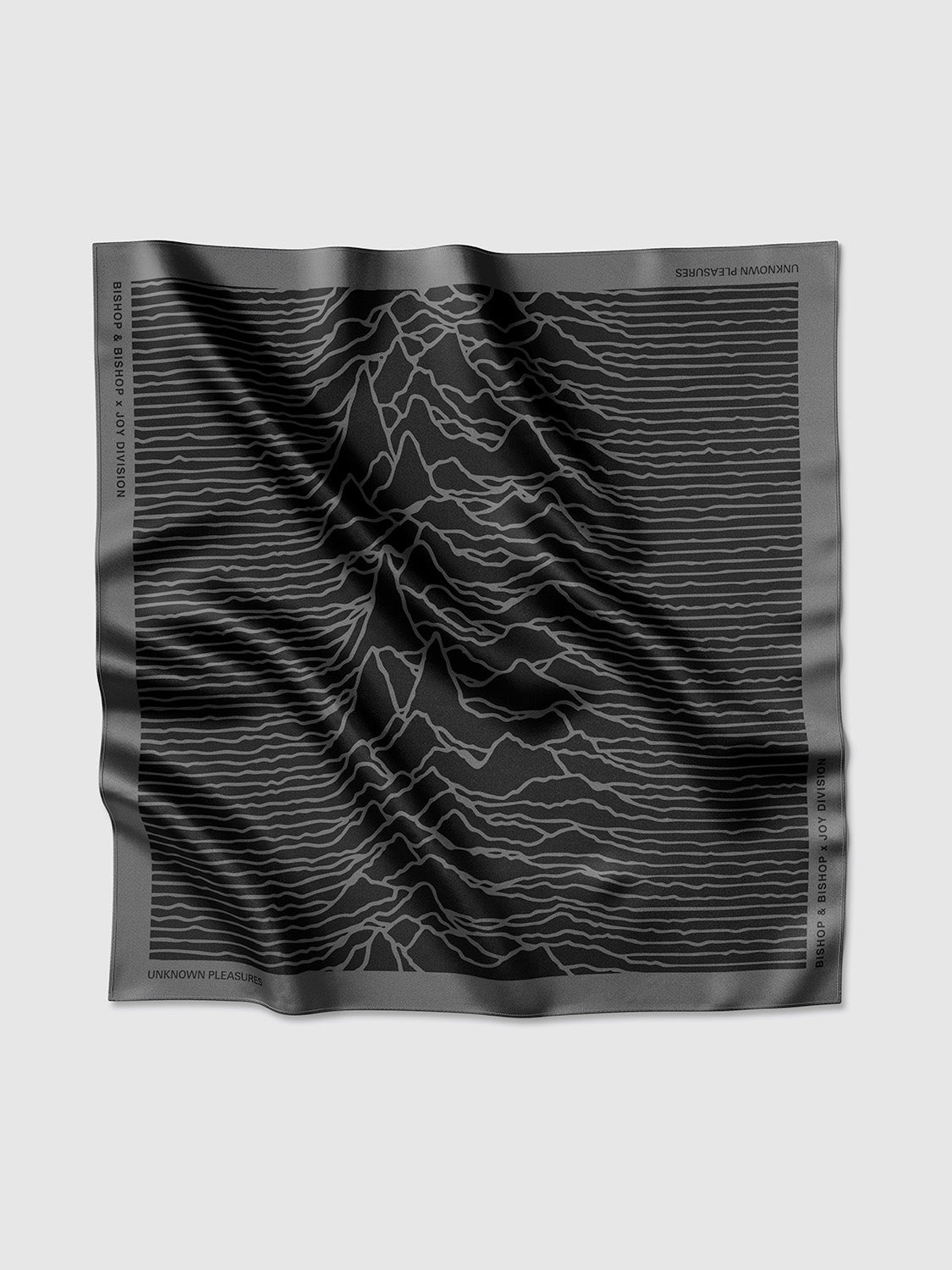 Flat lay of the square black and grey silk shawl featuring the full Unknown Pleasures waveform design.