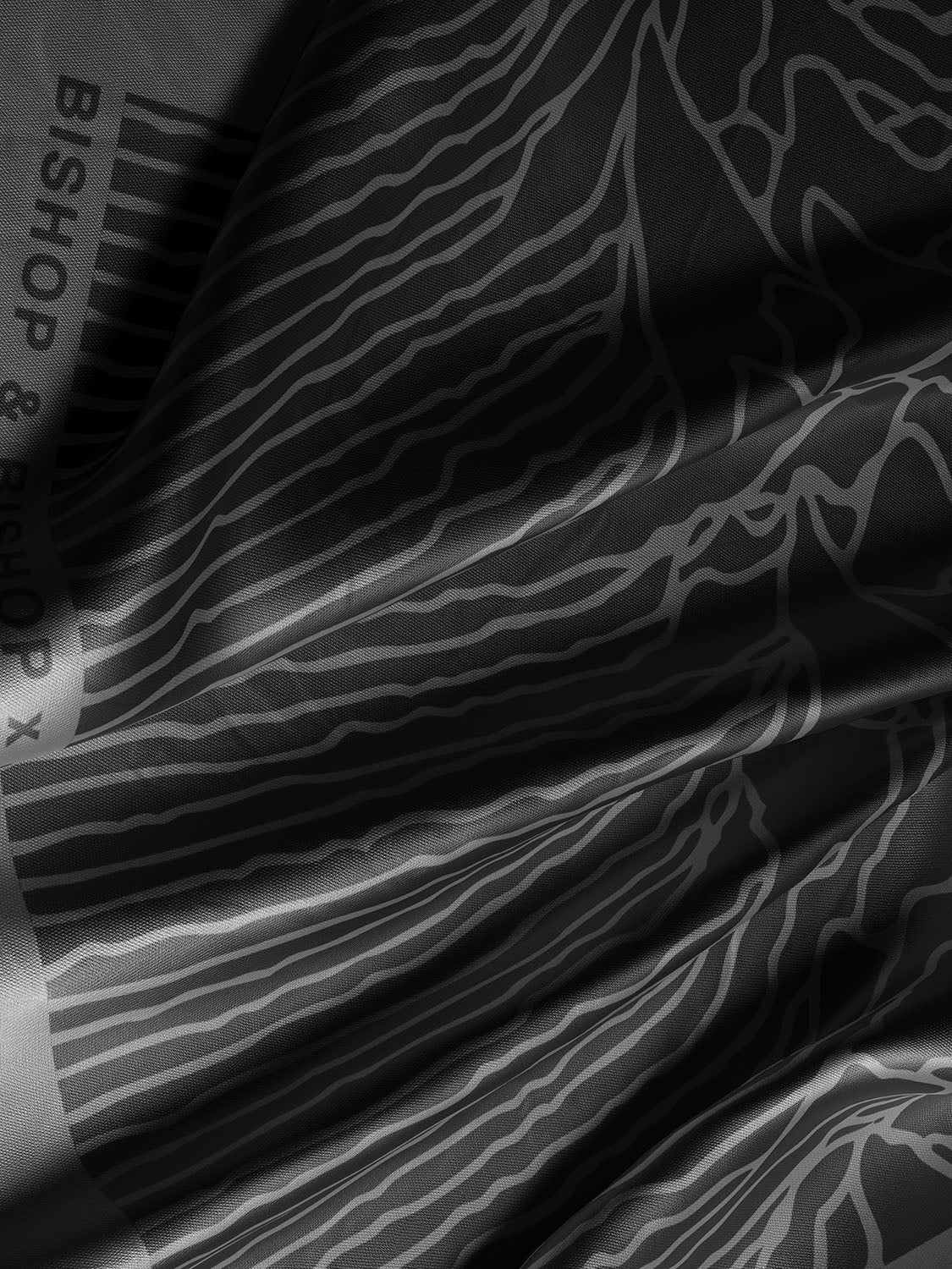Zoomed-in detail of the shawl’s soft silk texture and the intricate grey waveform lines.