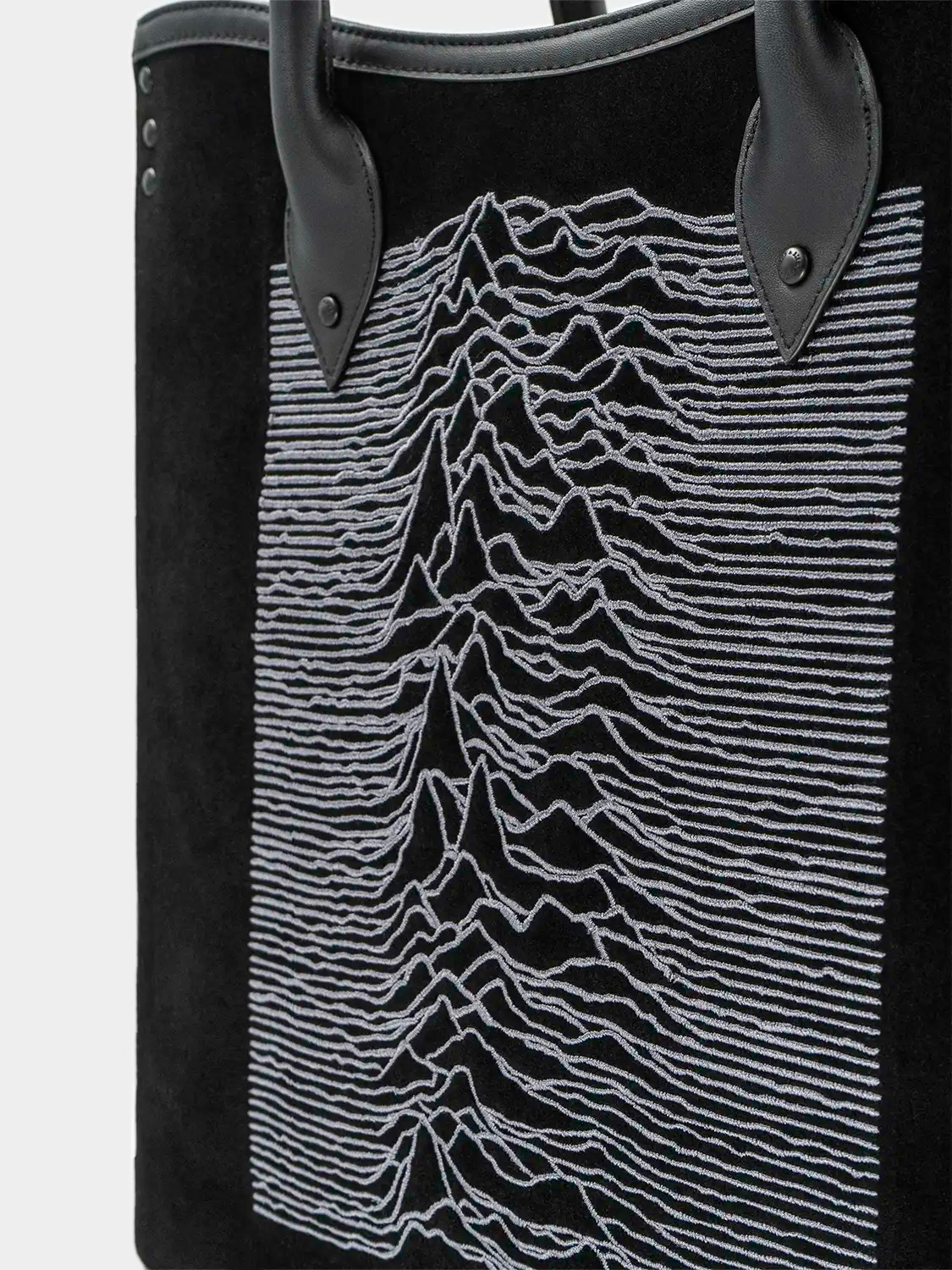 Zoomed-in view of the embroidery texture showing the fine white stitching of the waveform pattern.