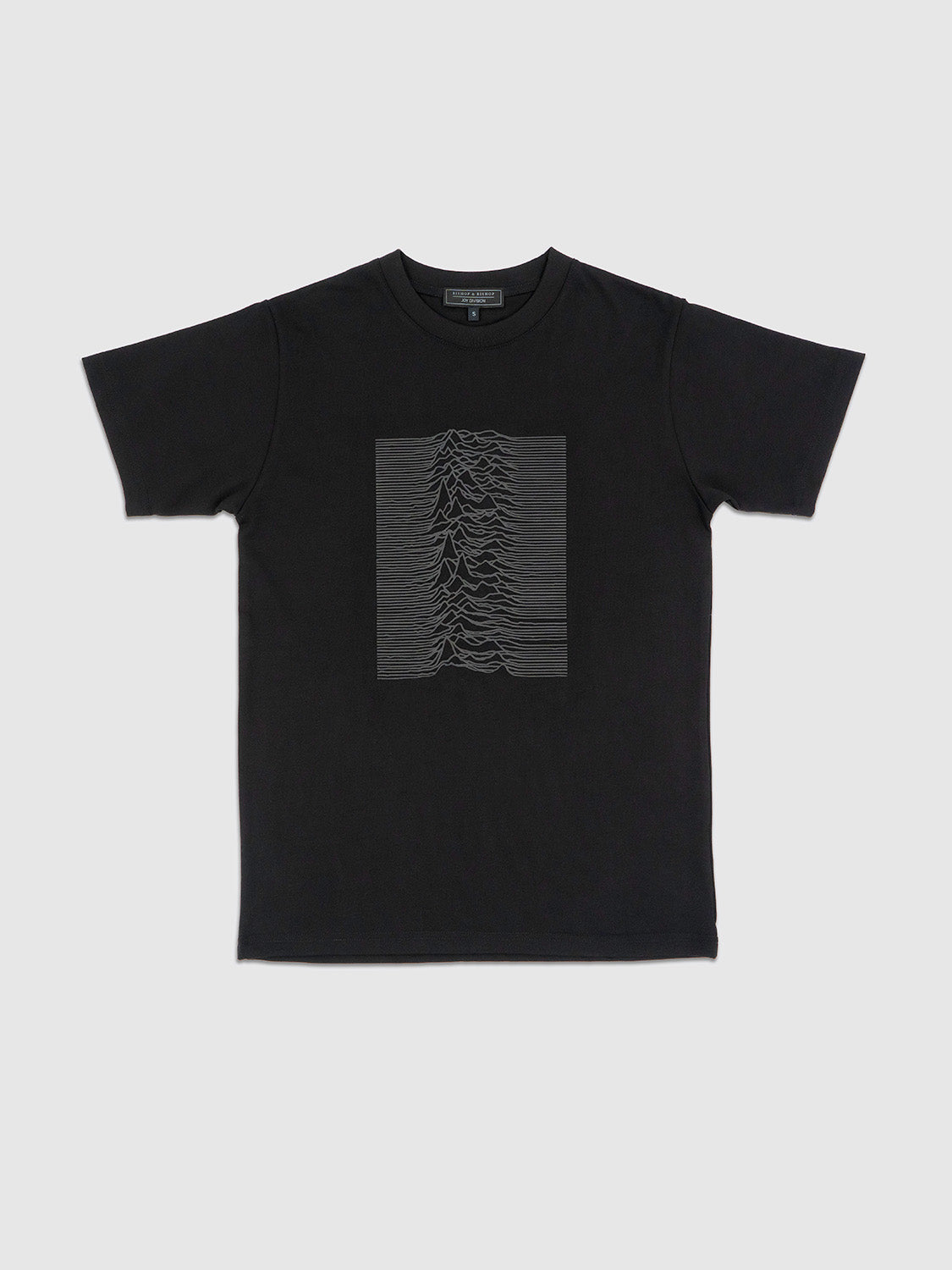 Front view of the black T-shirt featuring a grey 3D silicone print of the Unknown Pleasures waveform.