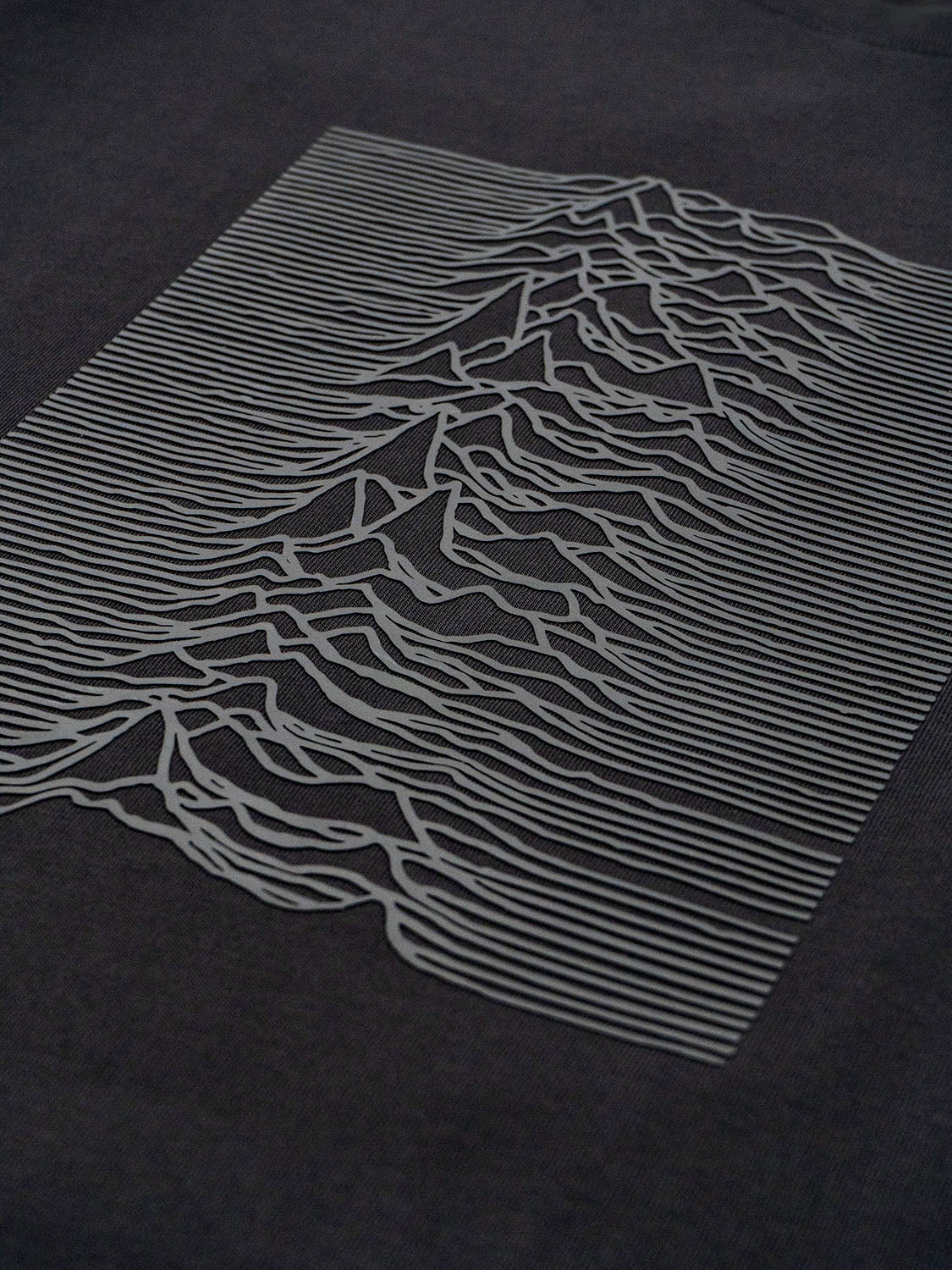 Angled front detail emphasizing the tactile grey silicone print and surface dimension.