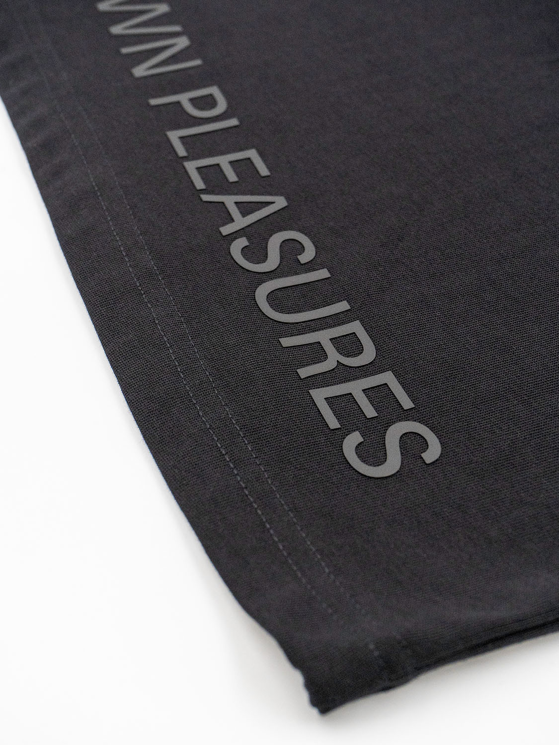 Side view of the fabric texture with light casting across the elevated silicone artwork.
