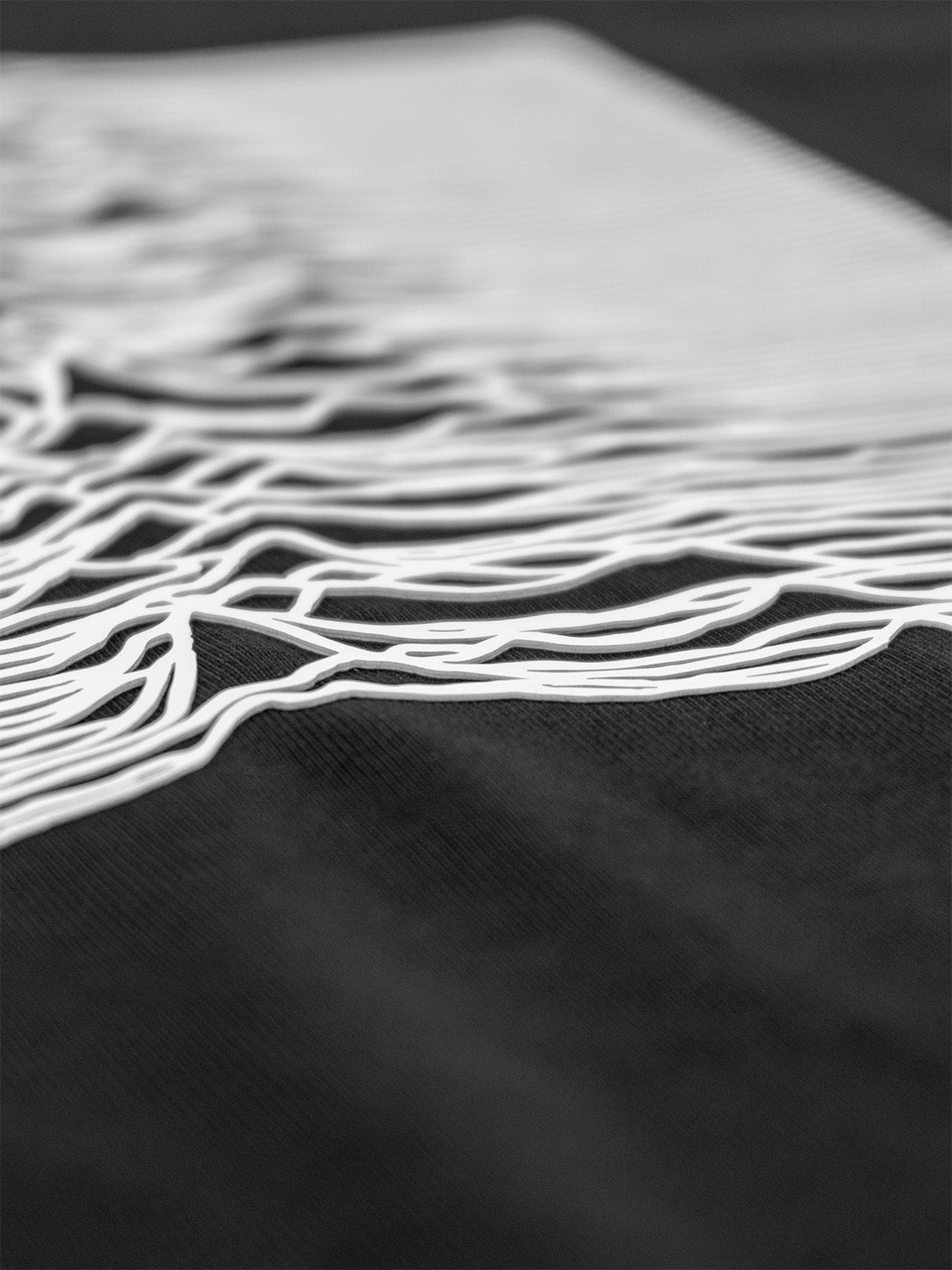 Close-up of the raised silicone print showing the dimensional texture of the waveform design.