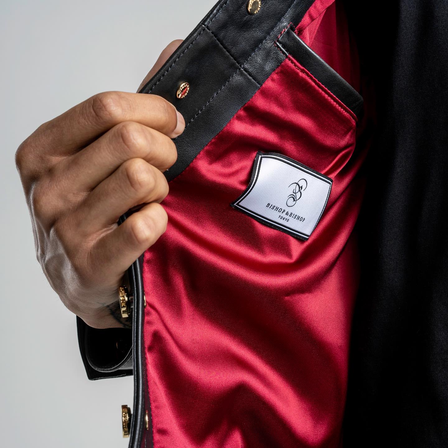 Close-up of a jacket’s interior, showing the red lining and Bishop & Bishop label.