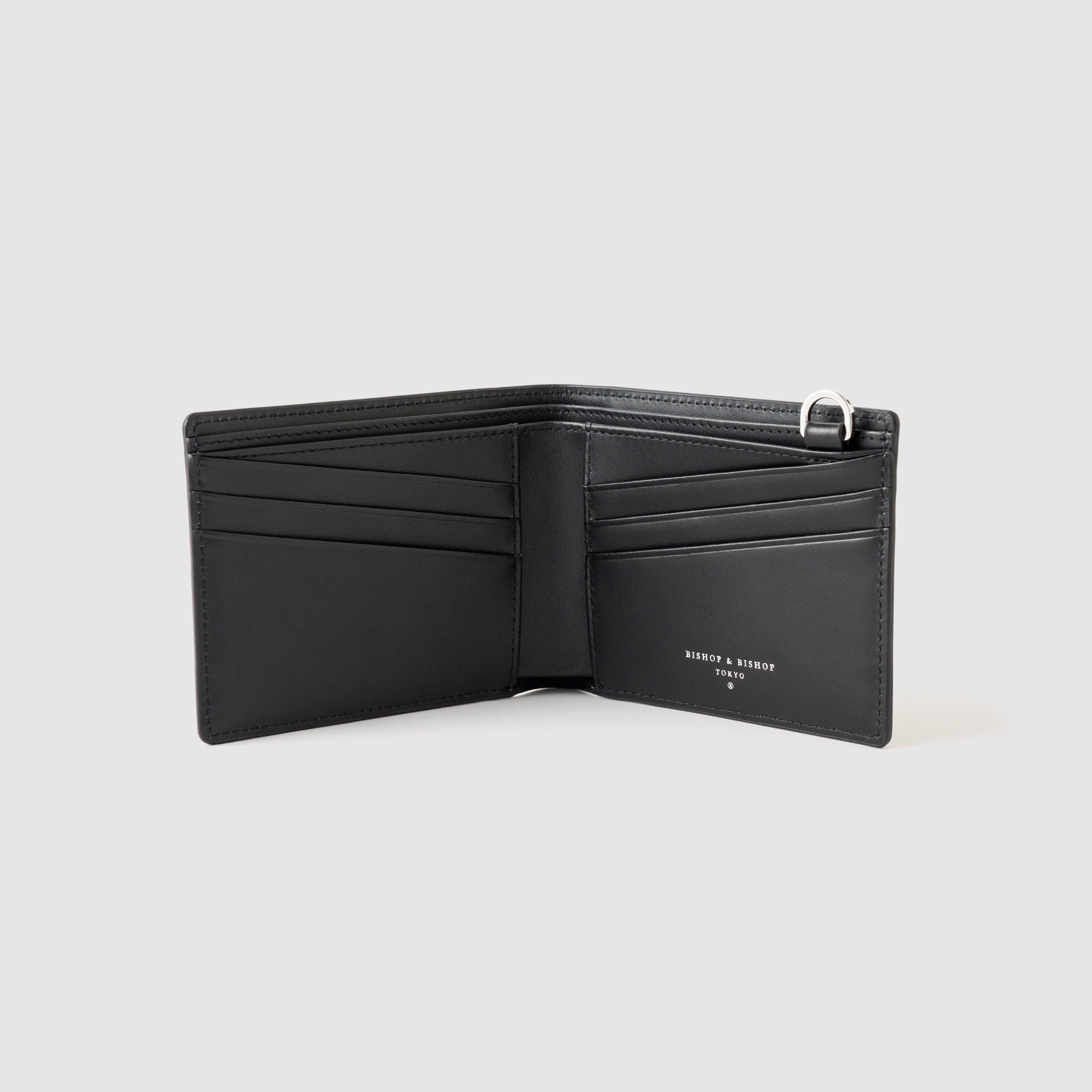 Black wallet with silver details, shown open on a gray background.
