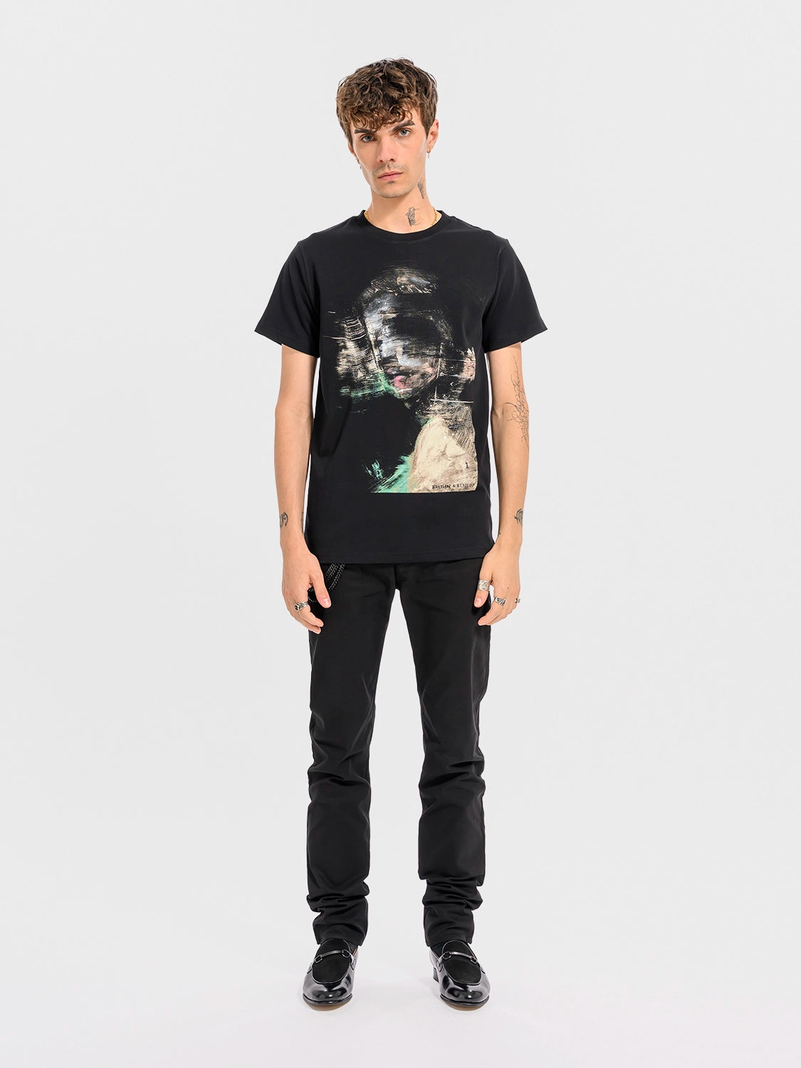 Person wearing a black t-shirt with a graphic design on a white background