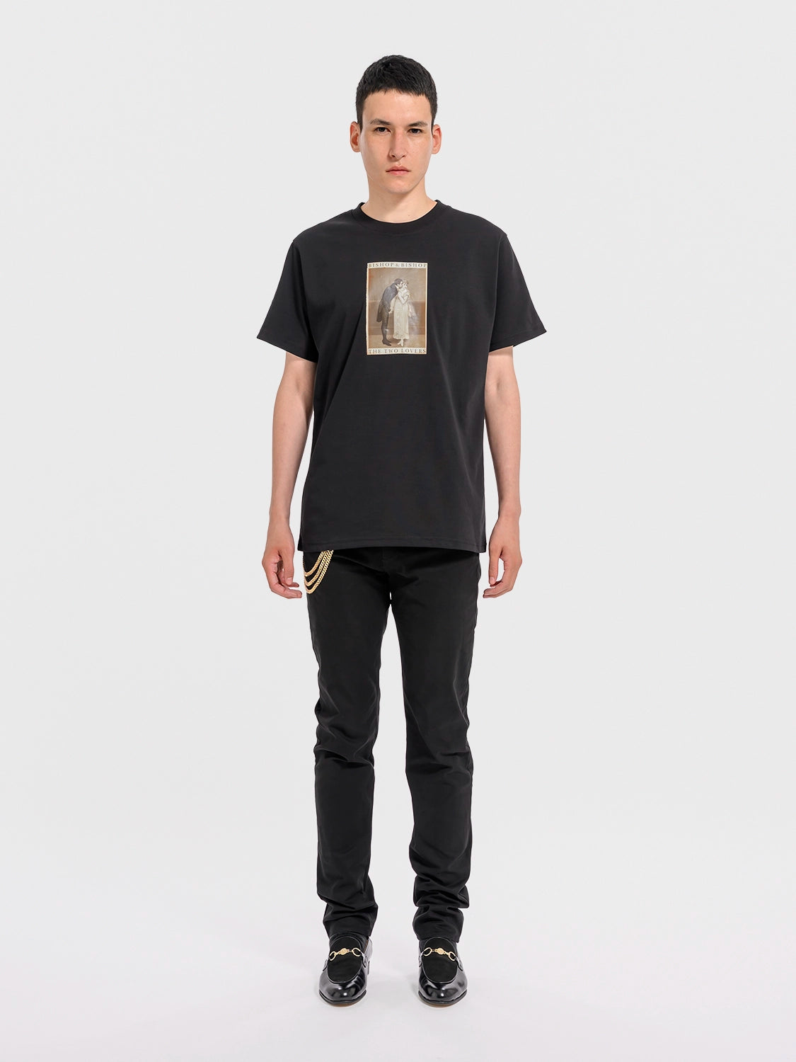 Person wearing a black t-shirt with a graphic design on a white background