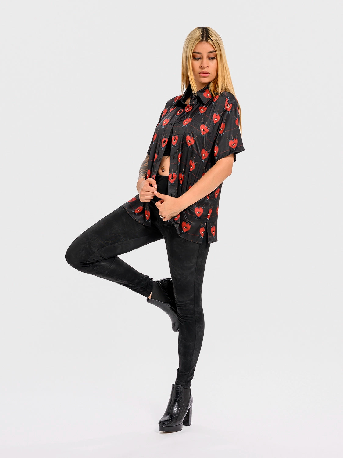 Side-angle view of a woman wearing the "Vires Ex Luctus" silk shirt, emphasizing silhouette, sleeve drape, and luxurious texture.